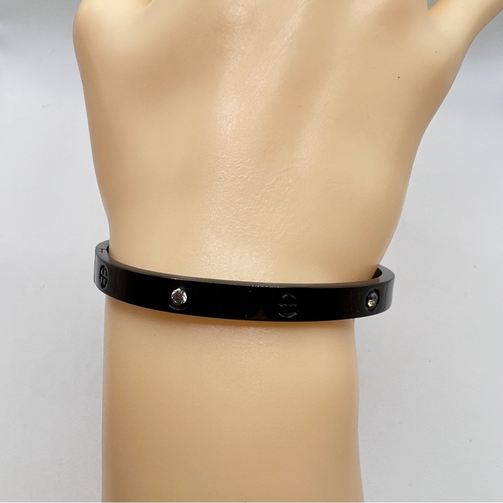 Black metal with simulated diamonds, love bracelet.